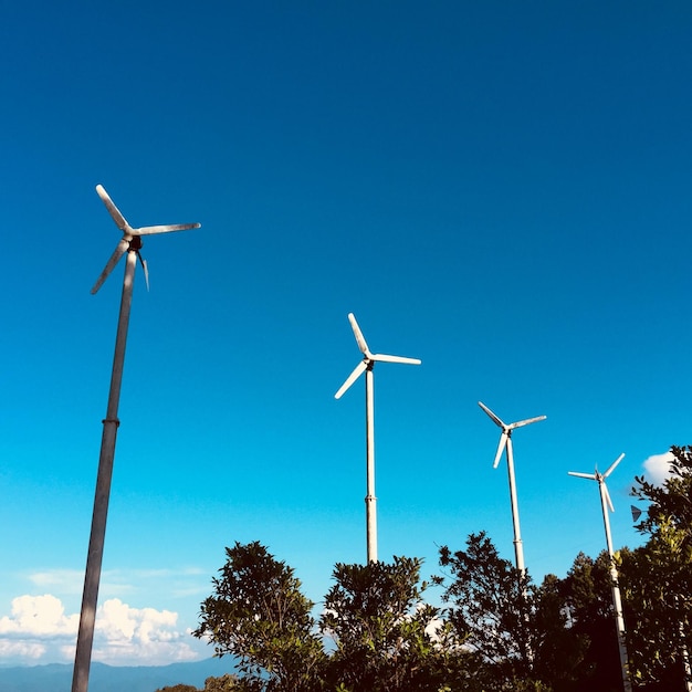 Foto vista a basso angolo della turbina eolica contro un cielo blu limpido