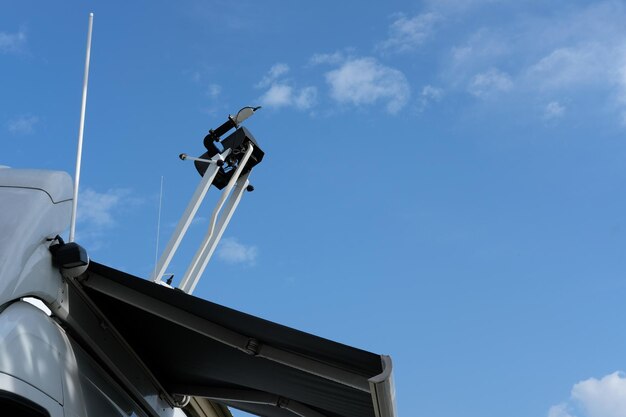 Low angle view of wind turbines on street against sky