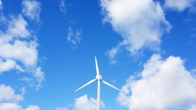 Low angle view of windmill against blue sky