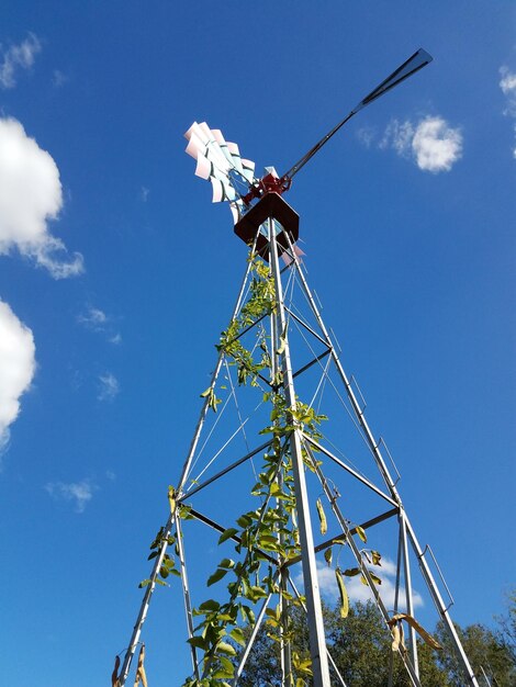 Low angle view of windmill against blue sky