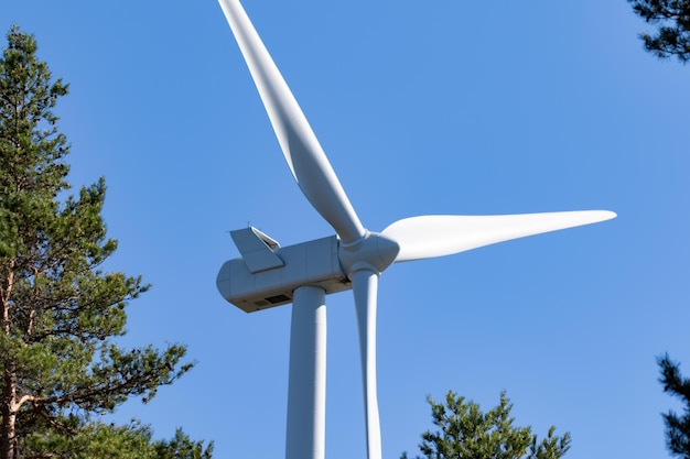 Low angle view of windmill against clear blue sky