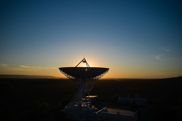 Low angle view of windmill against clear sky during sunset