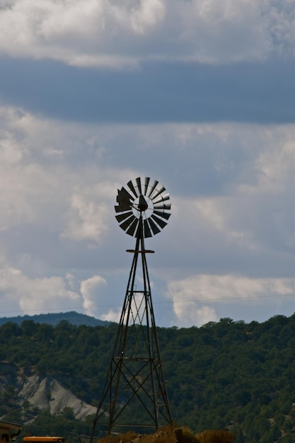 Foto vista a bassa angolazione del mulino a vento contro un cielo nuvoloso
