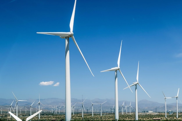 Low angle view of windmill on field against sky