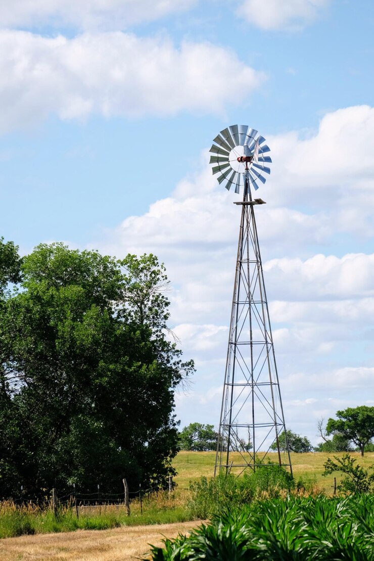 फोटो low angle view of windmill on field against sky