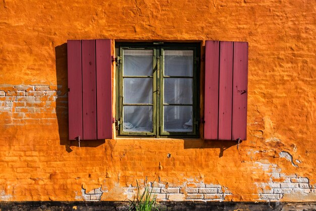 Low angle view of window on wall of building