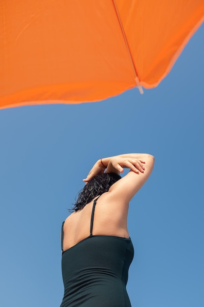 Low angle view of woman against clear sky