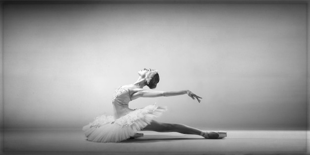 Low angle view of woman dancing against white background