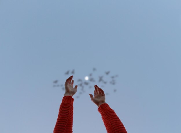 Photo low angle view of woman flying against clear sky