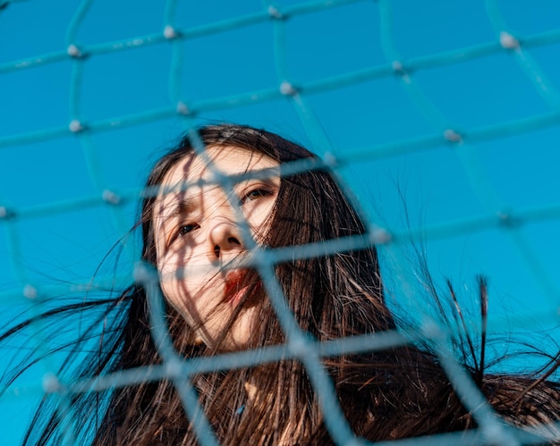 Low angle view of woman seen through net