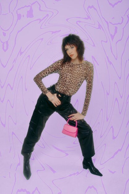 Low angle view of woman standing against purple background