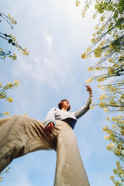 low angle view of woman standing against sky