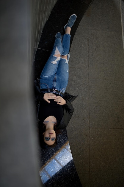 Low angle view of woman standing against wall