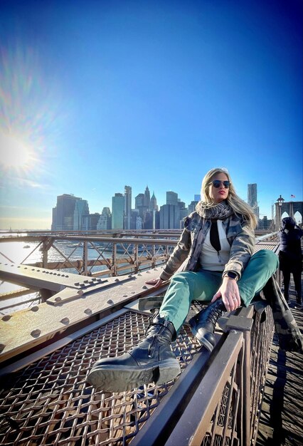 Low angle view of woman standing on bridge