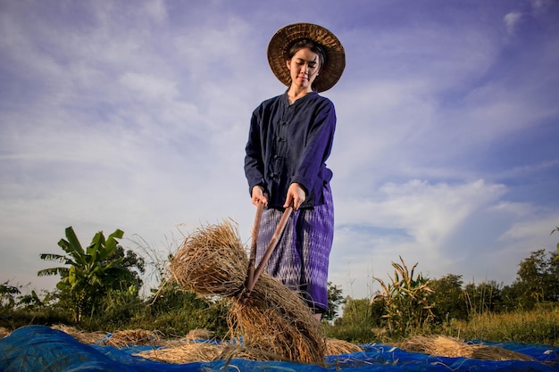 Low angle view of woman standing on field against sky