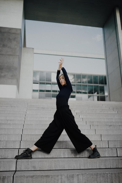 Low angle view of woman standing on staircase against building
