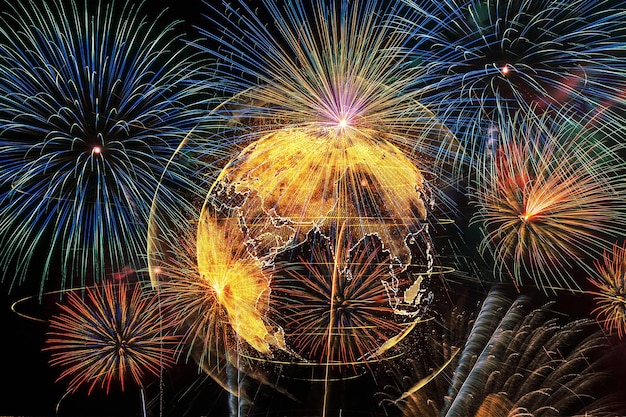 low angle view of world map with firework display in sky at night
