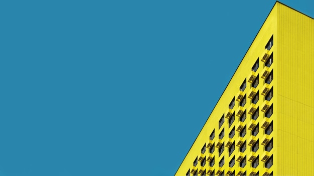low angle view of yellow building against blue sky