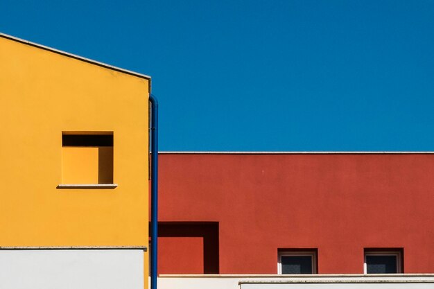 Low angle view of yellow building against clear sky