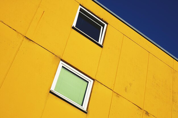 Low angle view of yellow building against clear sky