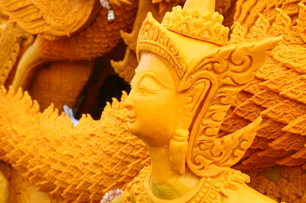 Low angle view of yellow female statue at temple