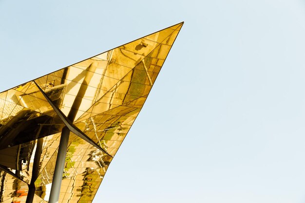 Low angle view of yellow flag against clear sky