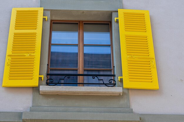 Low angle view of yellow house window on building