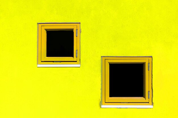 Low angle view of yellow house window