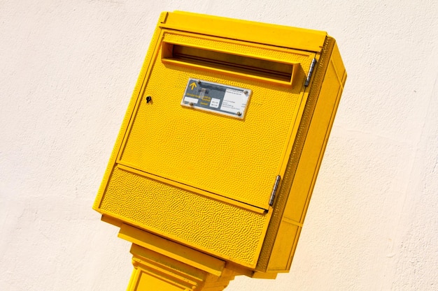 Low angle view of yellow mailbox on wall