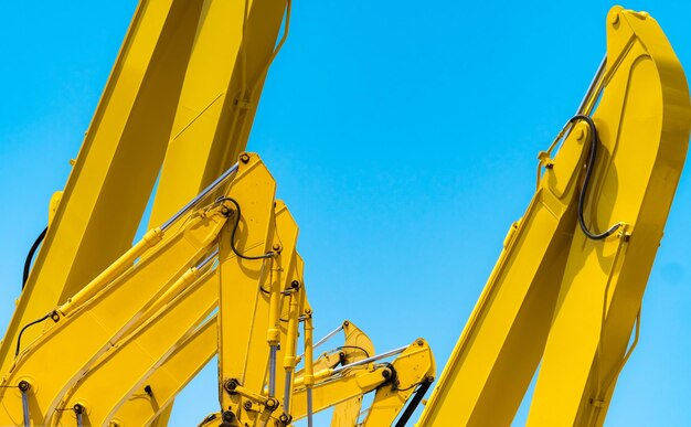 Low angle view of yellow wheel against clear blue sky