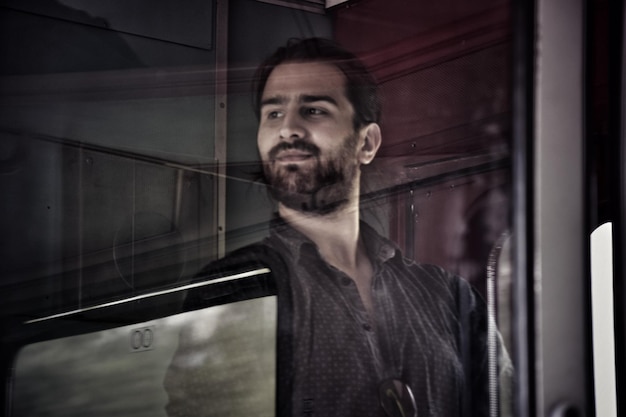 low angle view of young man seen through window