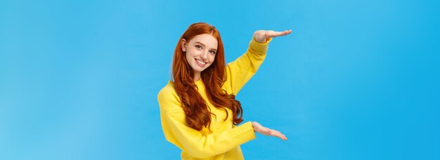 Low angle view of young woman against blue background