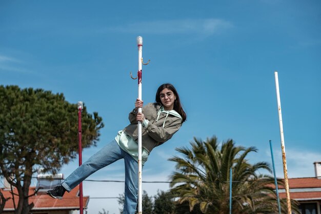 Low angle view of youth jumping against sky