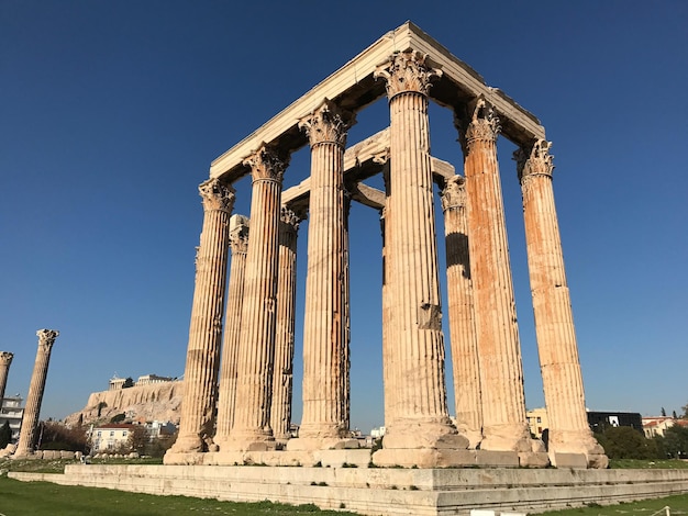 Low angle view of zeus temple against blue sky on sunny day