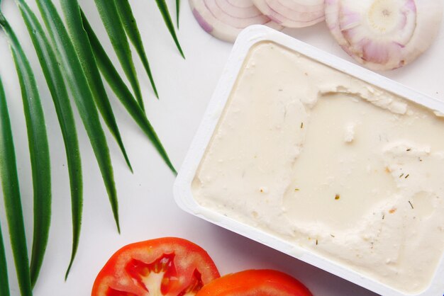 Low fact cheese cream in a container on table