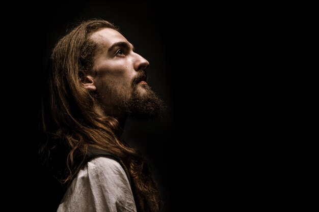 Low key portrait of bearded medieval peasantin profile