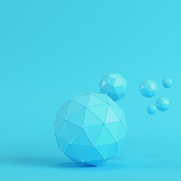 Low poly abstract spheres on bright blue background