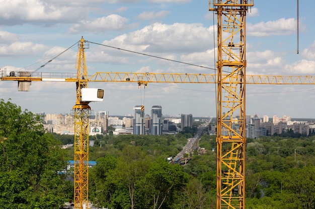 Low rise building concept: tower cranes at the construction of a townhouse