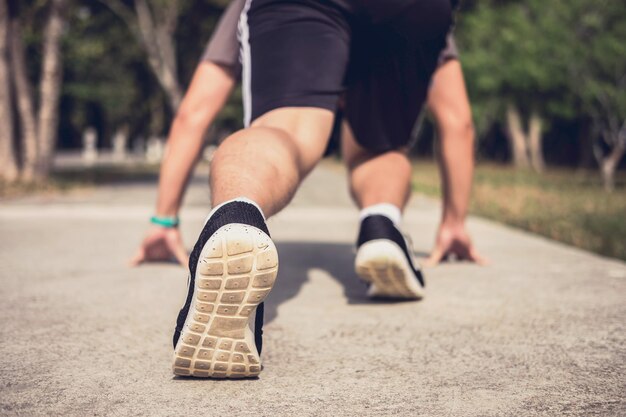 Foto sezione bassa di un atleta che corre su un sentiero