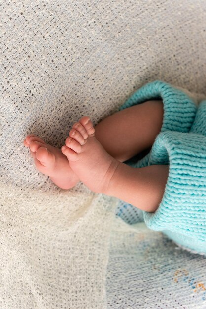 Low section of baby on bed