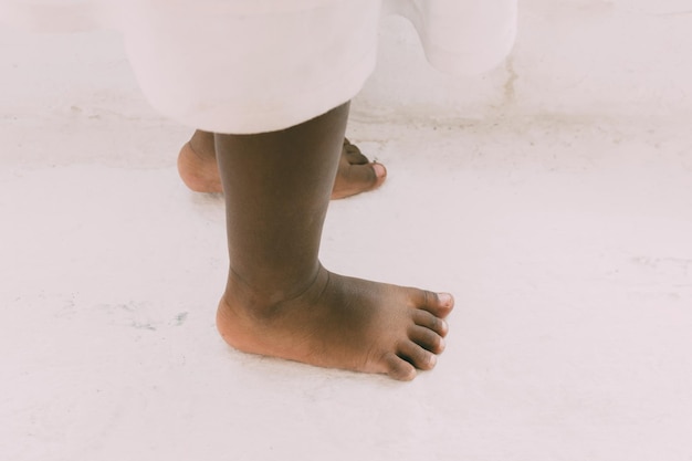 Low section of boy standing on footpath