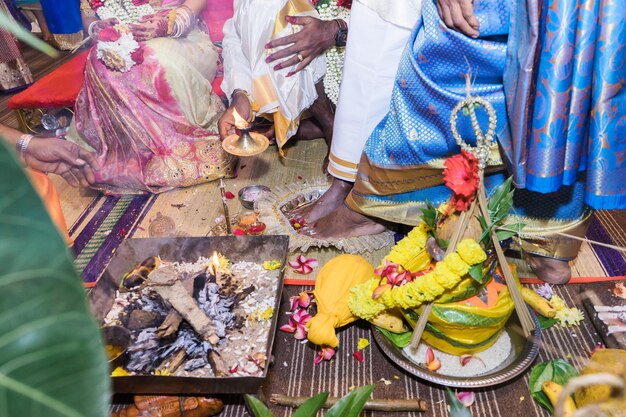 Low section of bride and groom doing wedding ceremony