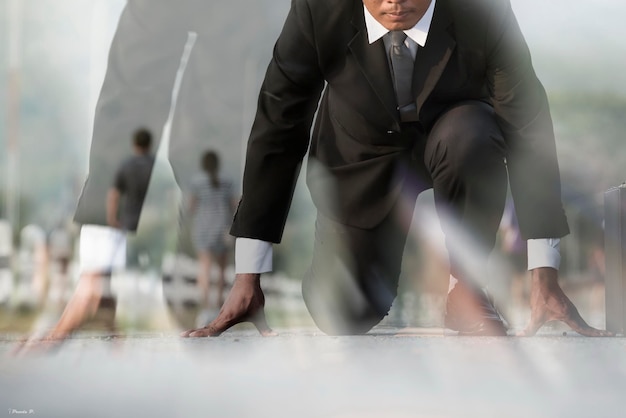 Low section of businessman kneeling on road