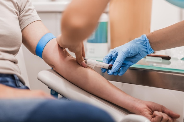 Low section of doctor examining patient in gym