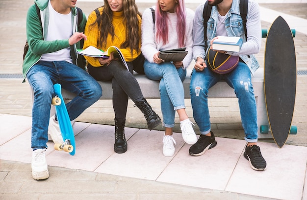 Low section of friends studying while on seat