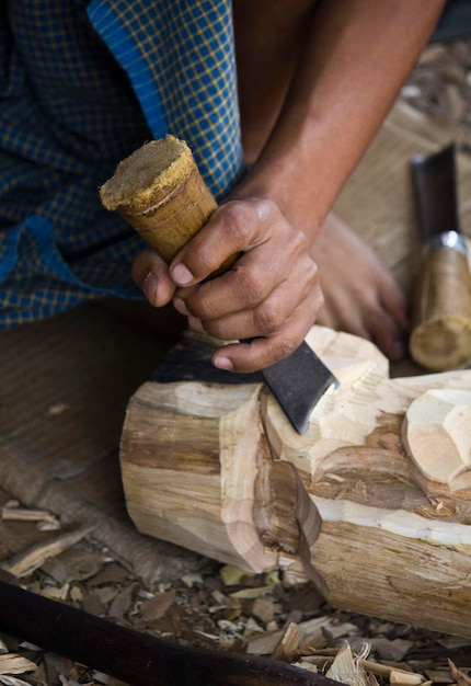 Photo low section of man carving wood in workshop