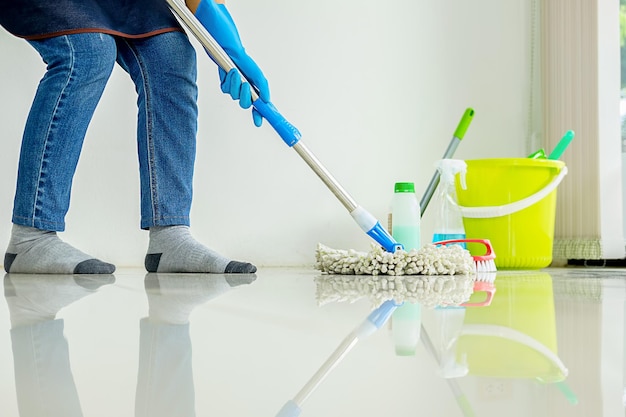 Low section of man cleaning floor