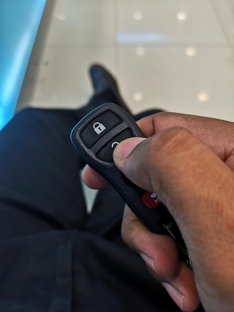 Low section of man holding car key