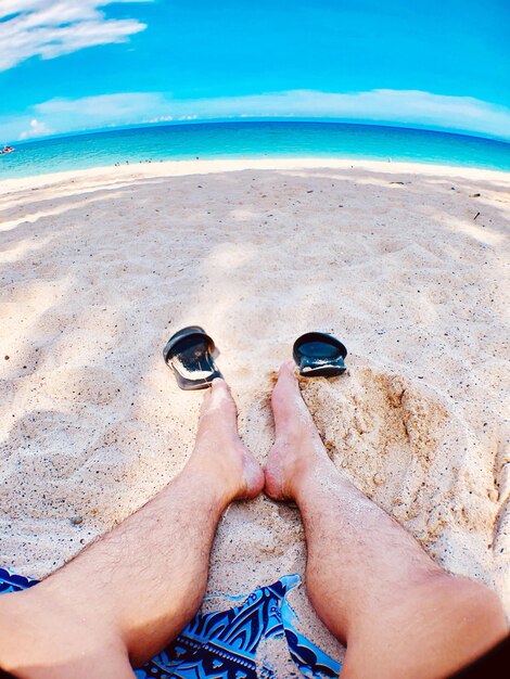 Low section of man legs on beach