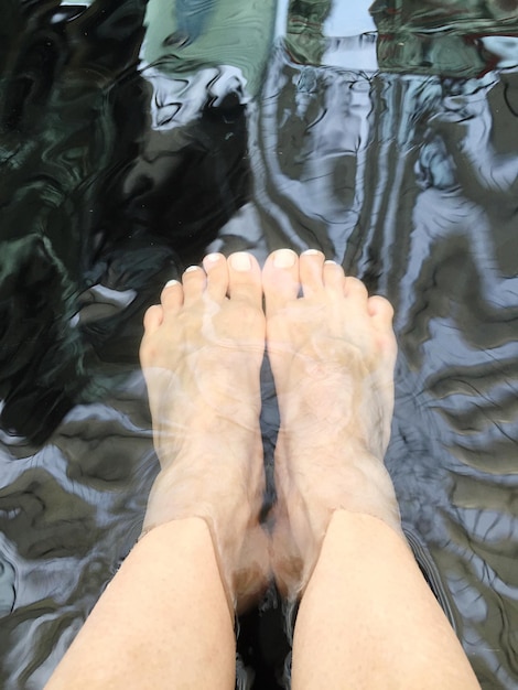 Low section of man legs in lake